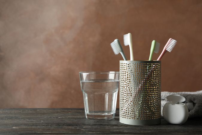 Tools for dental care on brown background, space for text