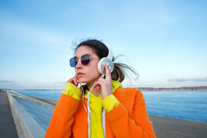 Woman with headphones on the beach
