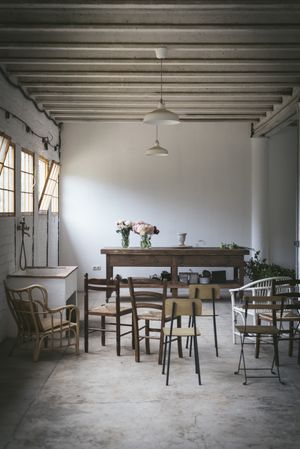 Empty room with flowers on table and chairs
