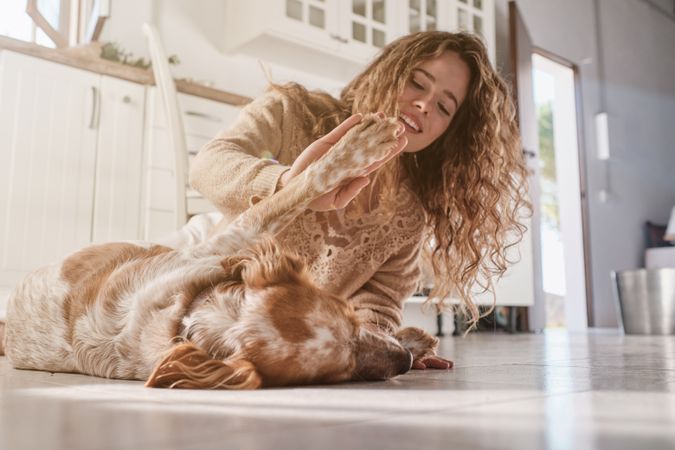 Happy woman having fun with Spaniel dog