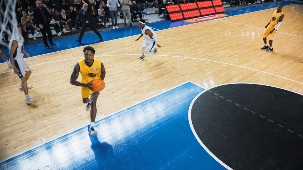 Cinematic College Basketball Tournament: Two Young Successful Diverse Teams Play a Championship Match in a Modern Arena.