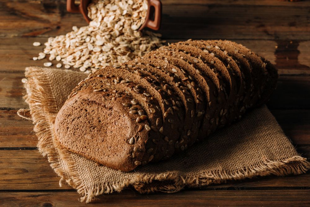Freshly baked rye bread on napkin on table