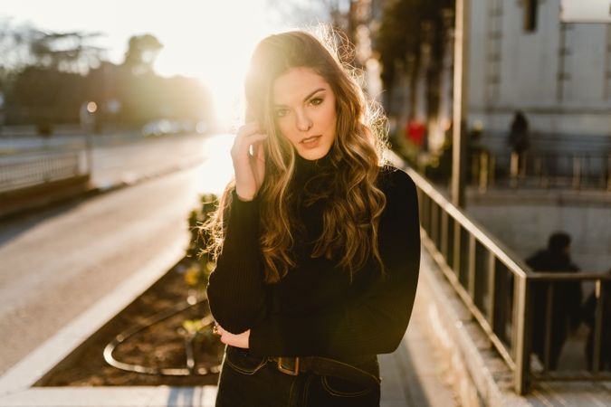 Stylish woman standing near metro station