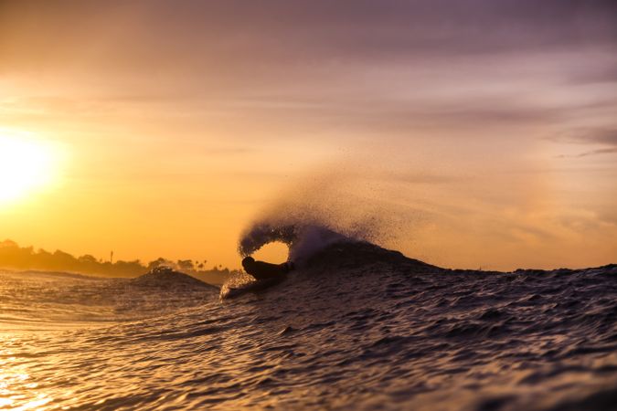 Man on surf board floating on wavy water