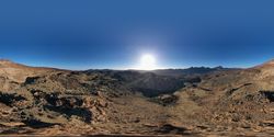 Sun shining above wild mountains