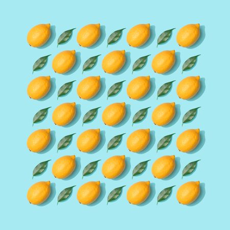 Lemons and leaves pattern on pastel blue background