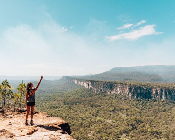 Woman in sports outfit standing on rock