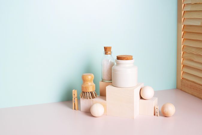 Natural personal care bathroom items stacked with blue wall behind