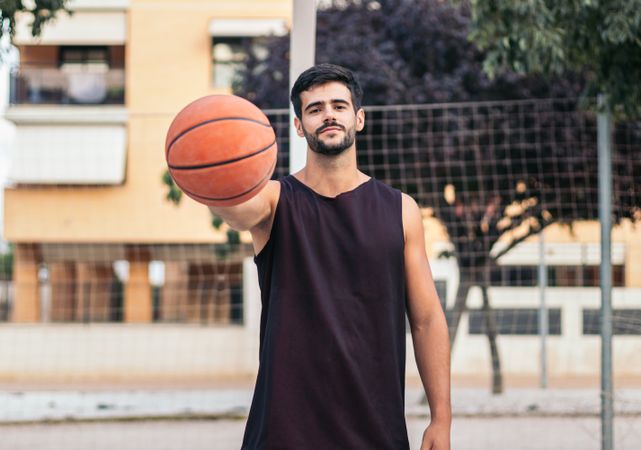 Confident Basketball Player Holding Ball with Determination