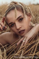 Portrait of young woman with purple make-up in wheat field 5wdXy4