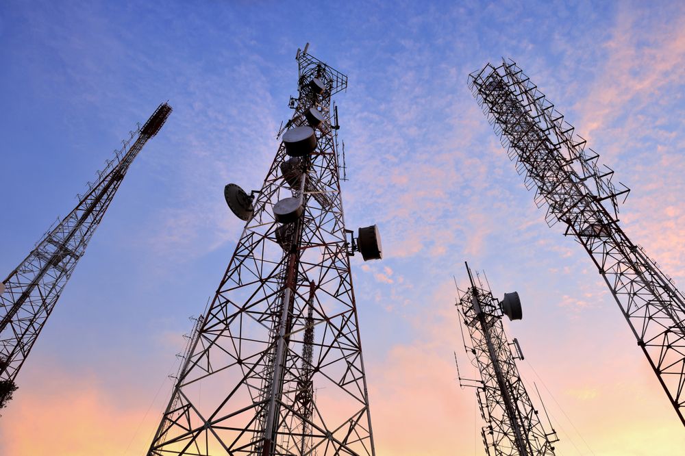 Telecommunication Towers Against a Vibrant Sunset Sky