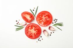 Tomatoes and ingredients on light background, top view