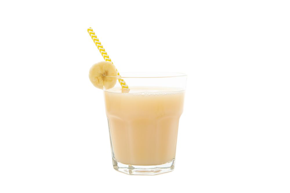 Banana juice isolated on blank background. Fresh fruit