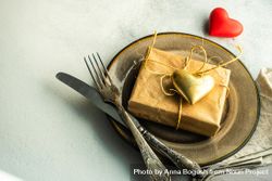 St Valentine day table setting with gift and gold heart, copy space 4mWWMW