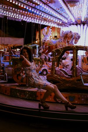 Woman enjoying ride on carousel