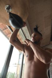Black guy boxing in gym