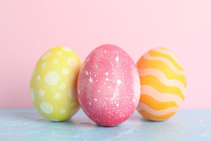 Decorated Easter eggs on color background, closeup. Space for text