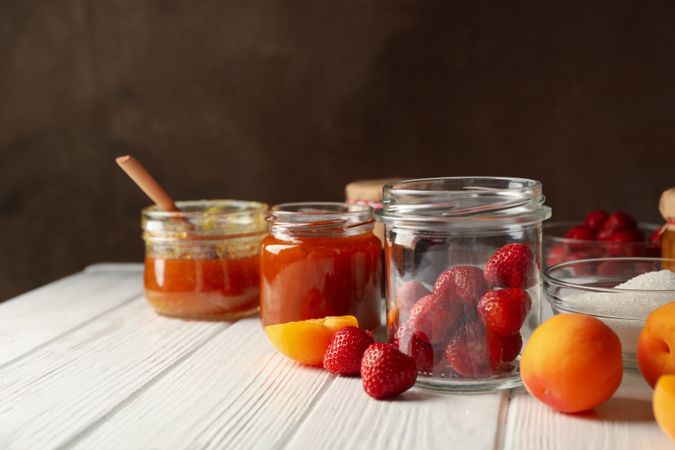 Composition with jam on wooden table. Preparing jam