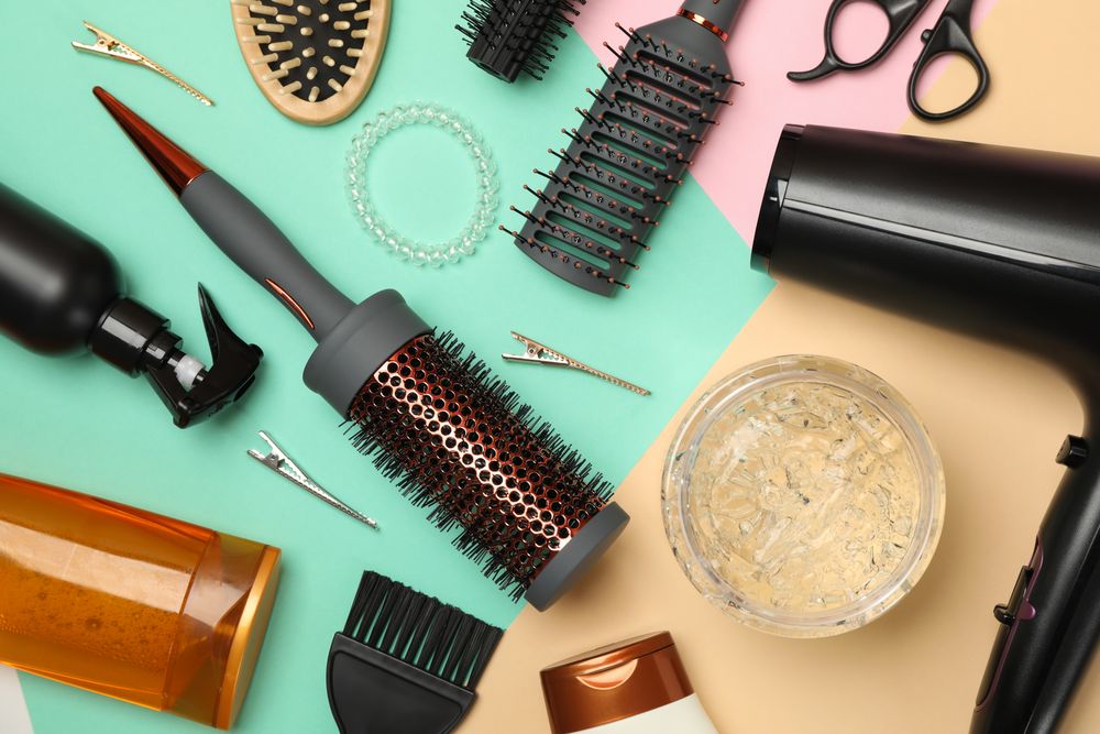 Composition with hairdresser accessories on three tone background
