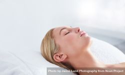Peaceful woman lying back receiving beauty treatment 0v3wvZ