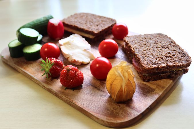 Close view on a healthy german breakfast with sandwiches, tomatoes and cucumbers