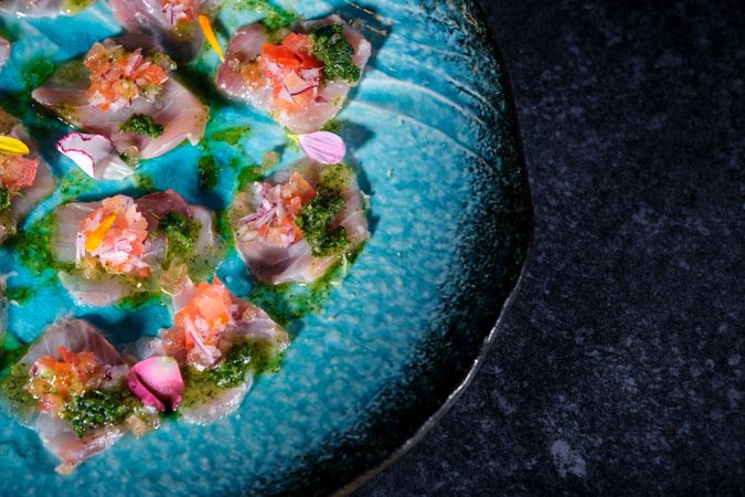 Plate with delicious fish dish on marble surface