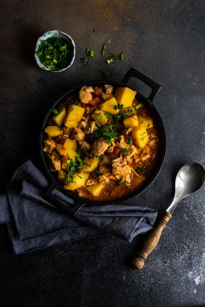 Top view of Georgian meat and vegetable stew Souzi served with herb, with copy space