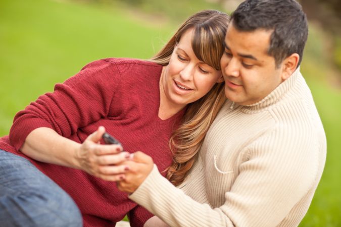 Couple Enjoying Their Camera Phone in the Park