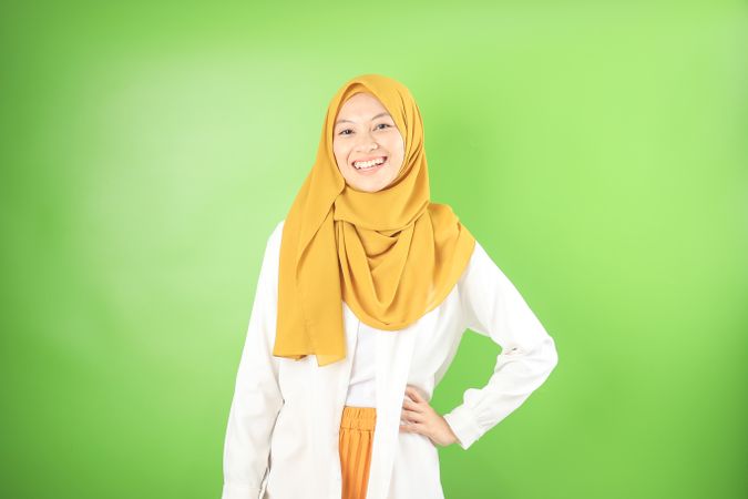 Smiling Female Standing with Veil While Her Hand on Hips