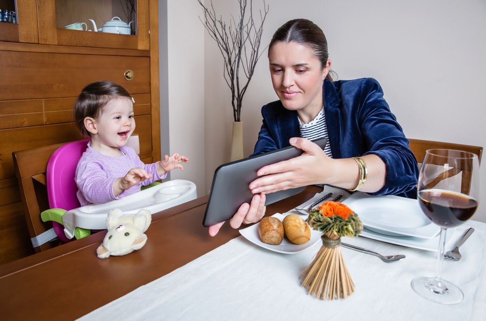 Businesswoman mother and baby girl looking tablet