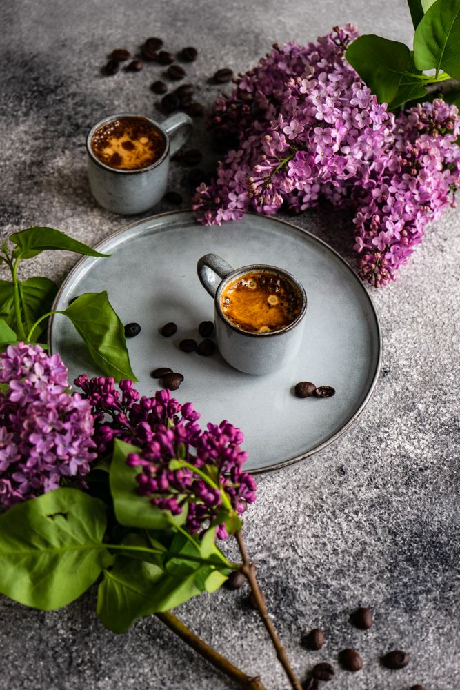 Coffee and lilac flowers with vertical composition