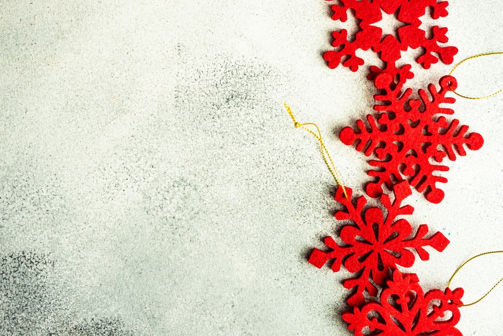 Flat red Christmas star ornaments on marble