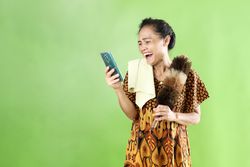 Indonesian Mom Wearing Looking at Cell Phone