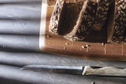 Sliced wholegrain bread on wooden cutting board