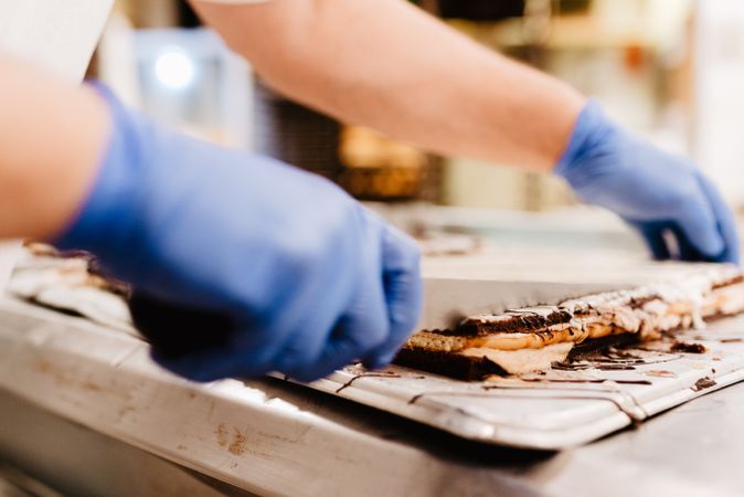 Crop confectioner cutting cake