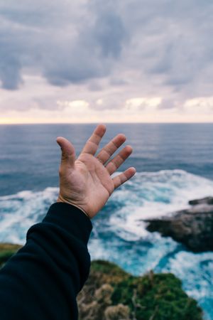 Person reaching for sea by hand