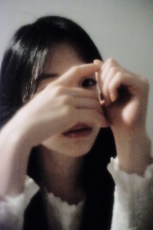 Portrait of young woman hiding her face