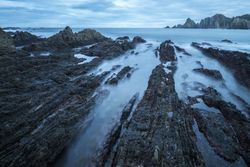 Foggy landscape of Playa de Gueirua rock seashore