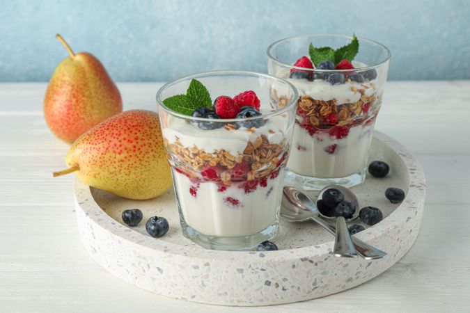 Parfaits and pears on wooden table, space for text