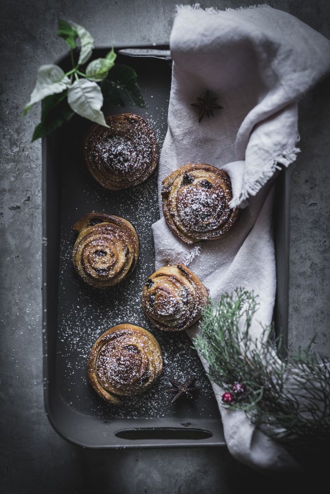 Herbs and napkin near cinnamon rolls