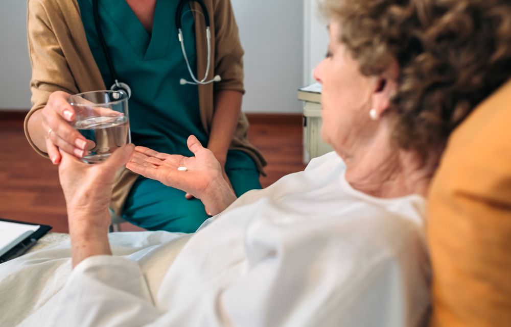 Doctor giving medication dose to mature patient