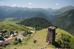Tall old defensive building in majestic mountains in summer sunny day