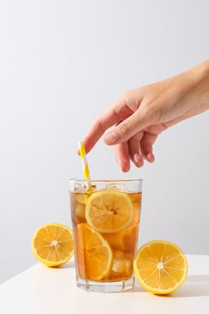 A glass of cold tea with fresh orange slices