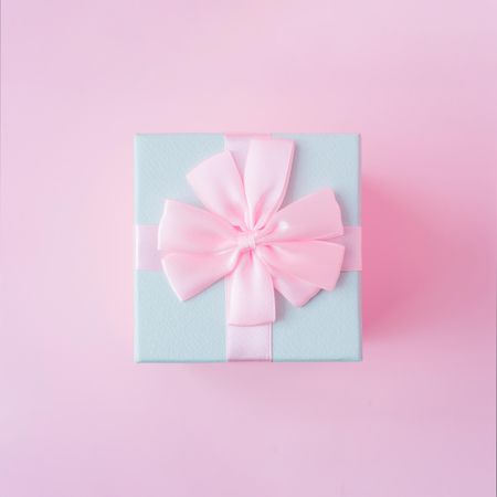 Top view of baby blue jewelry gift box on pastel backdrop