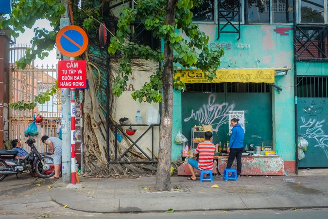 Back view of people at a food stand in Vietnam