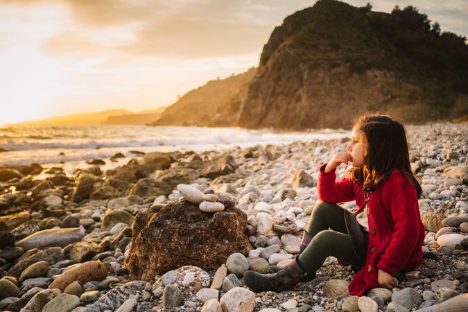 Dreamy girl resting on beach at sunset