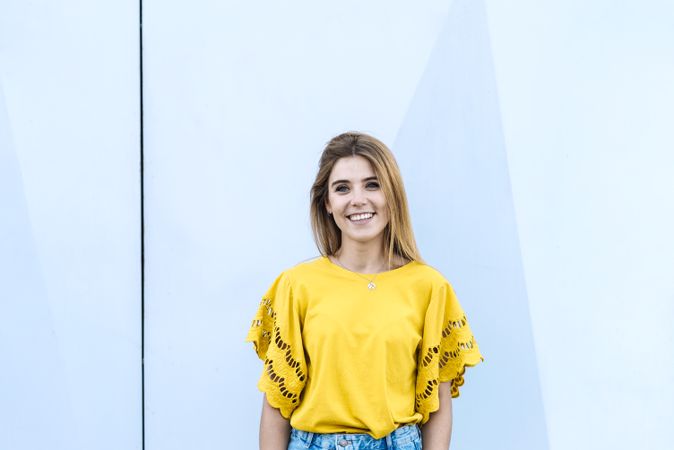 Young woman standing on plain background