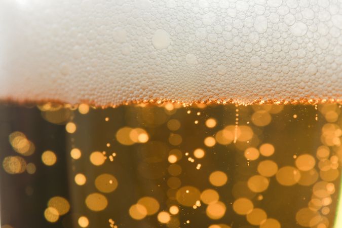 Beer and foam texture on whole background, close up