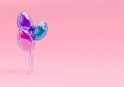 Creative Easter party with colorful balloons on pink background