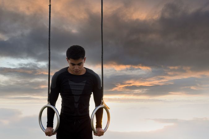 Sportsman training on gymnastic rings